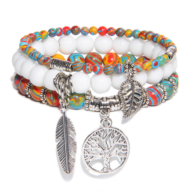 Multistrand bracelet with colorful beads and silver charms on a white background