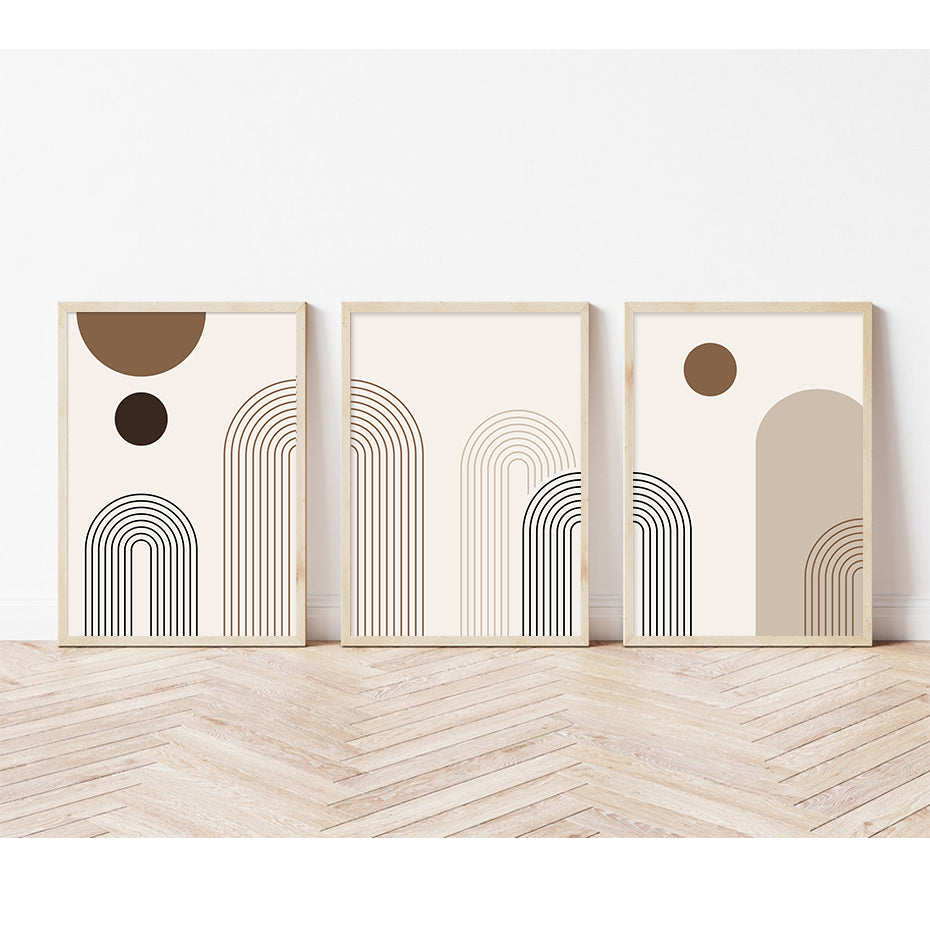 Three abstract art prints with geometric shapes on a white wall.