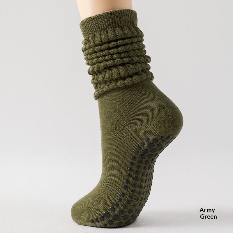 Army green sock with textured top and non-slip sole on a light gray background