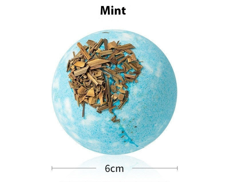 Bath bomb with mint leaves on a white background, labeled 'Bath Bombs Mint'.