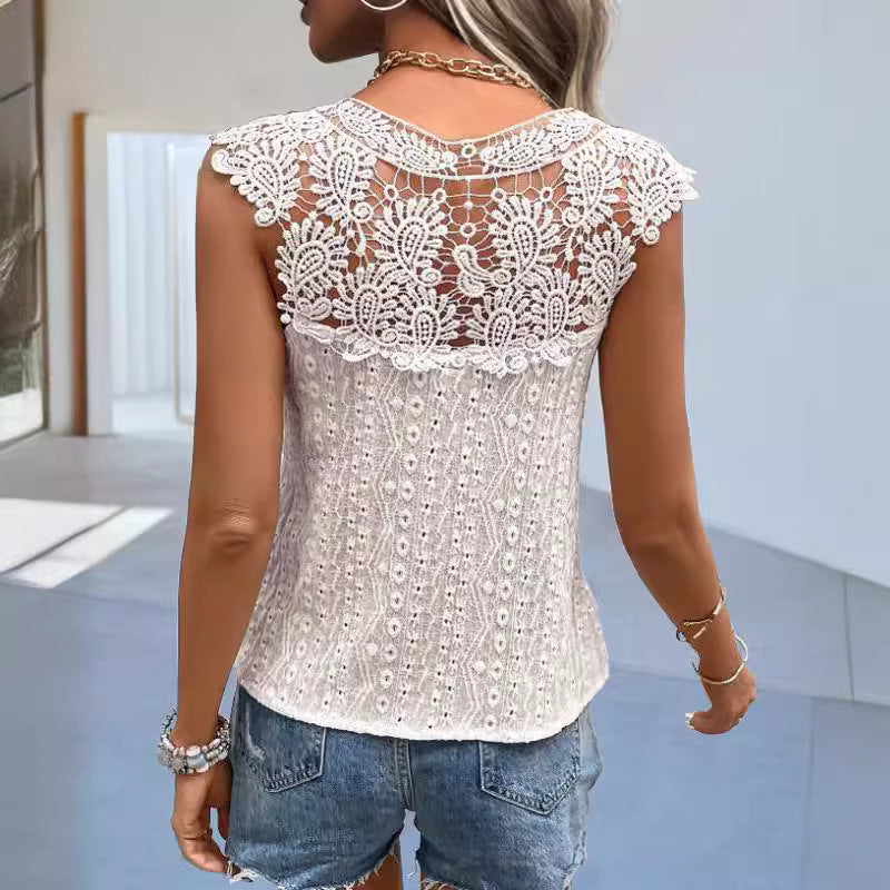 Woman wearing a white lace top and denim shorts in an indoor setting