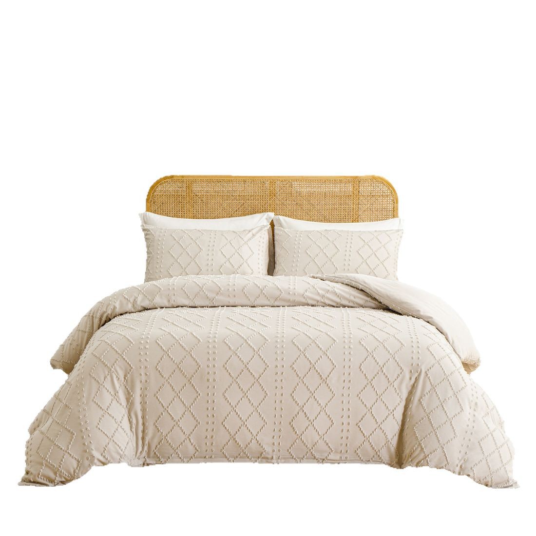 Beige quilted comforter set with pillows on a bed with a wooden headboard.