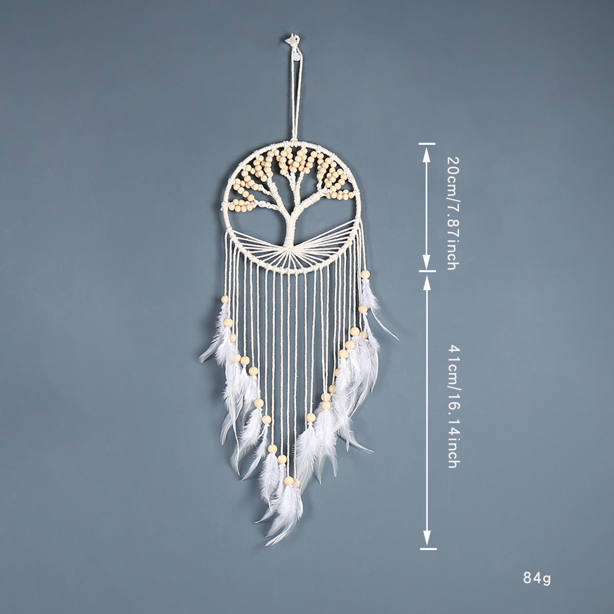 White dreamcatcher with feathers and measurements on a gray background