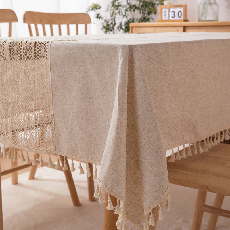 Beige tablecloth with lace trim on a wooden table