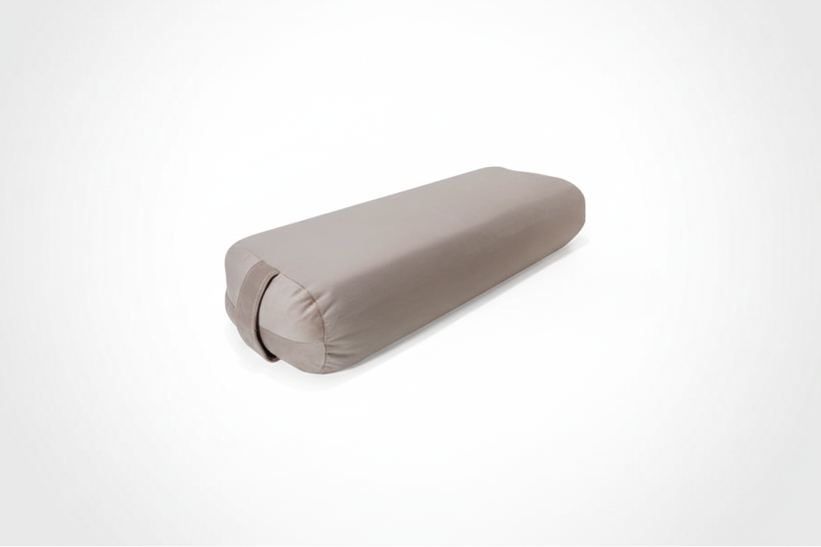 Beige yoga bolster on a white background