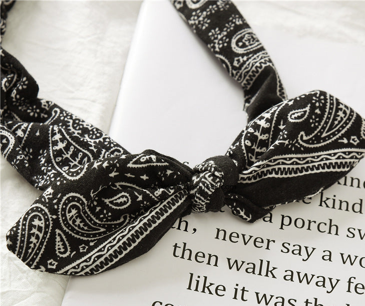 Black and white paisley headband on a book