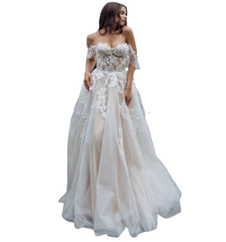 White lace off-shoulder gown on a white background