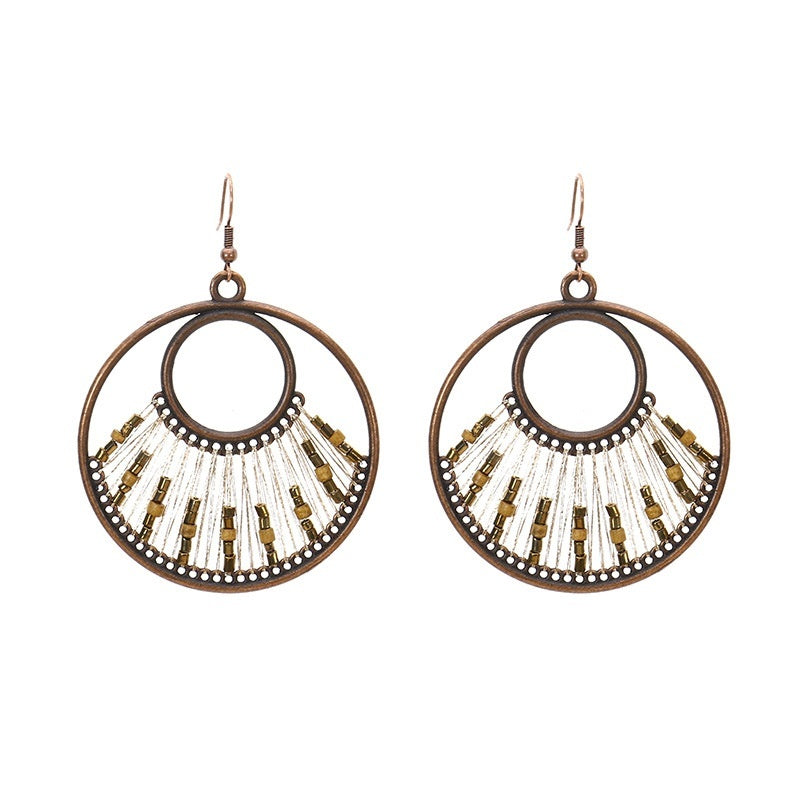 Pair of hoop earrings with bead detailing on a white background