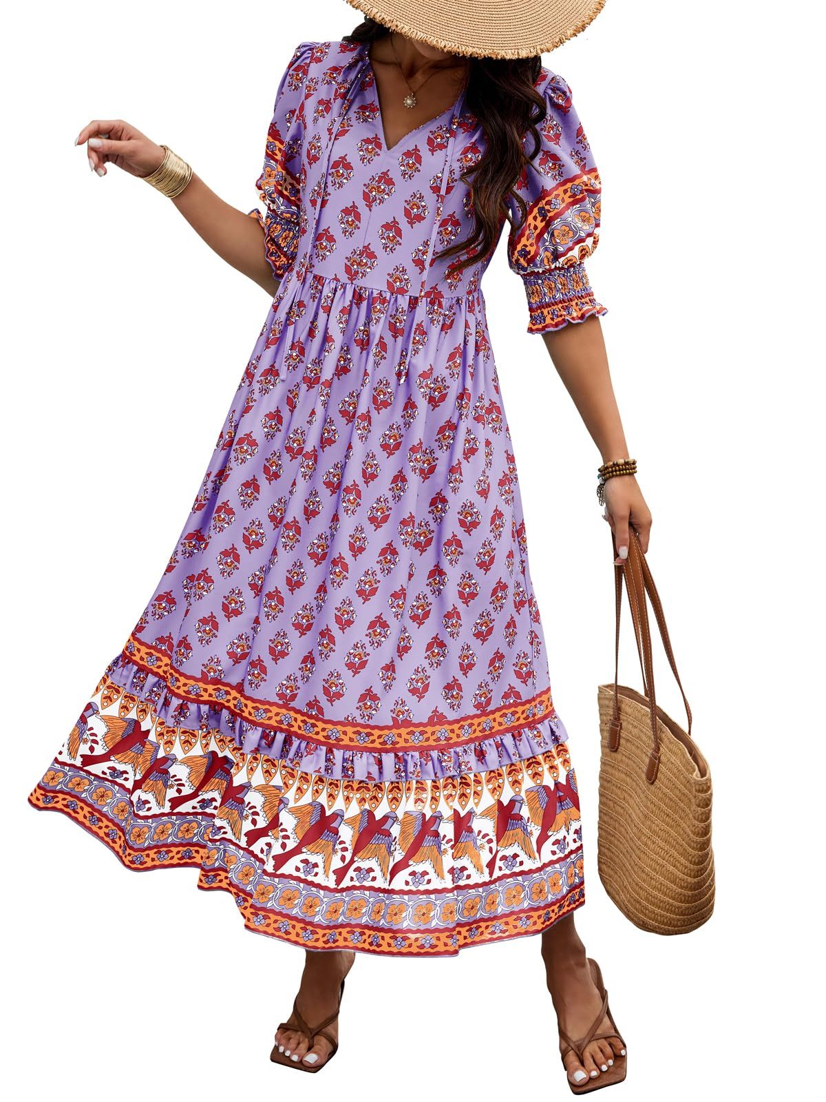 Woman wearing a purple floral dress with a white background