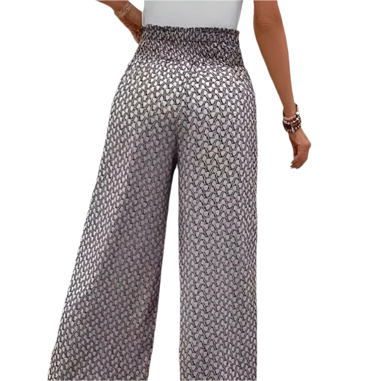 Wide-leg pants with a subtle pattern worn by a person on a white background