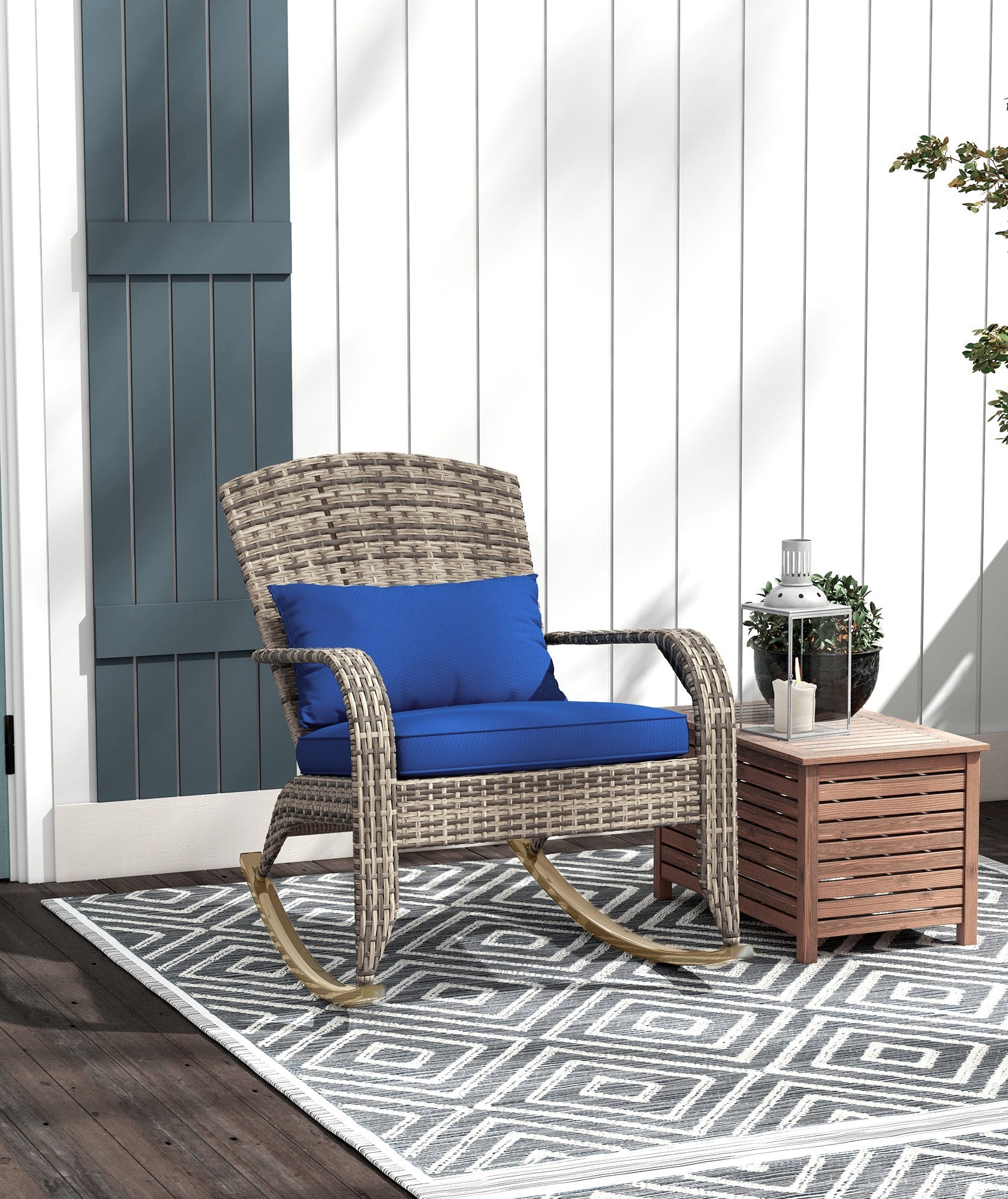 Outdoor patio set with wicker chair, blue cushion, and wooden side table on a patterned rug.