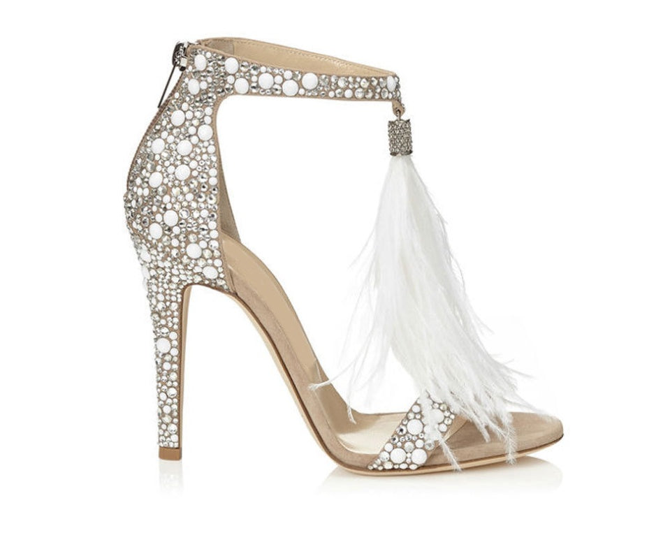 Elevated sandal with rhinestone embellishments and white feathers on a white background