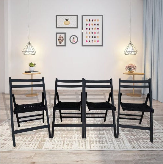 Four black chairs arranged in a row in a room with light-colored walls and decor.