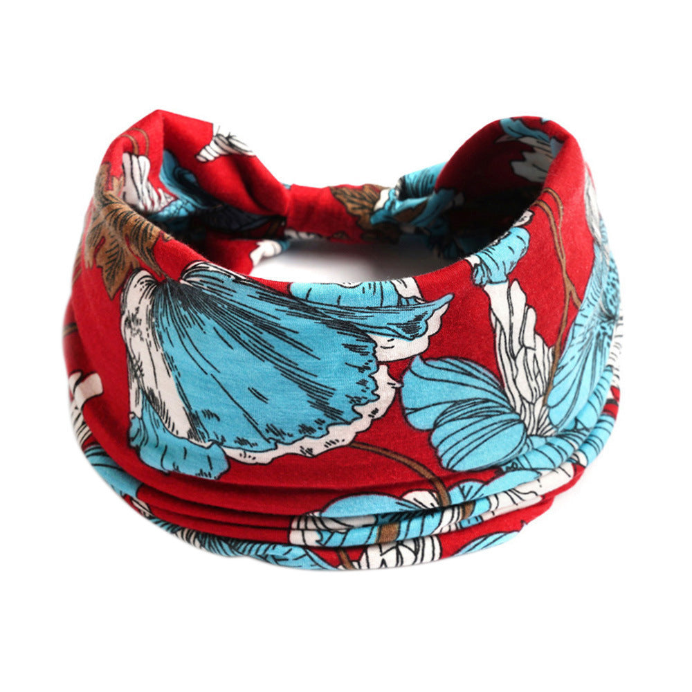 Red bandana with blue floral patterns on a white background