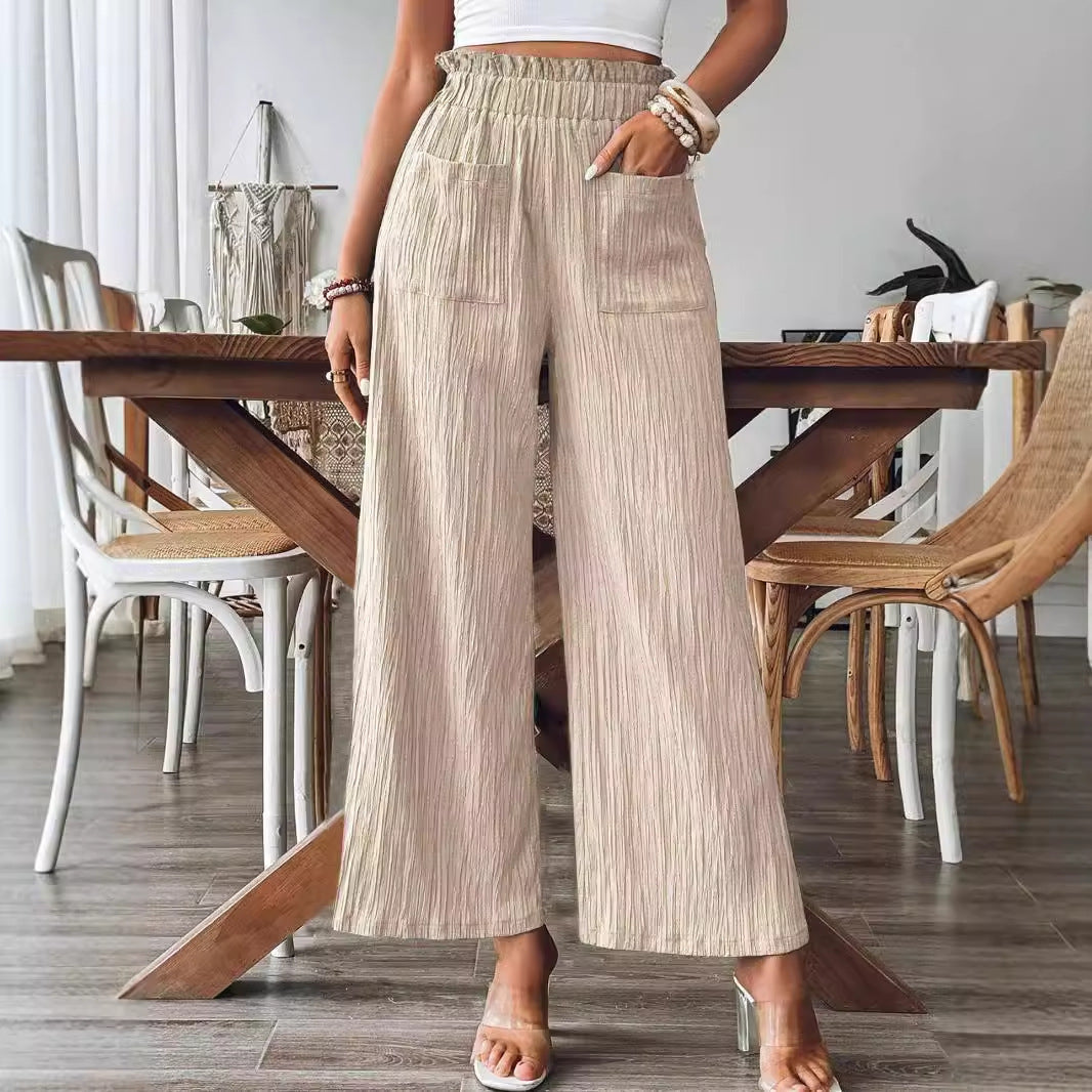 Person wearing beige wide-leg pants in a dining room setting