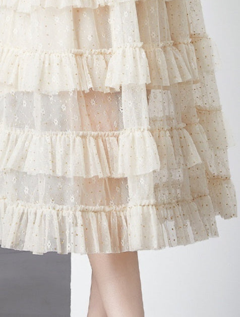 Layered beige skirt with floral patterns on a white background