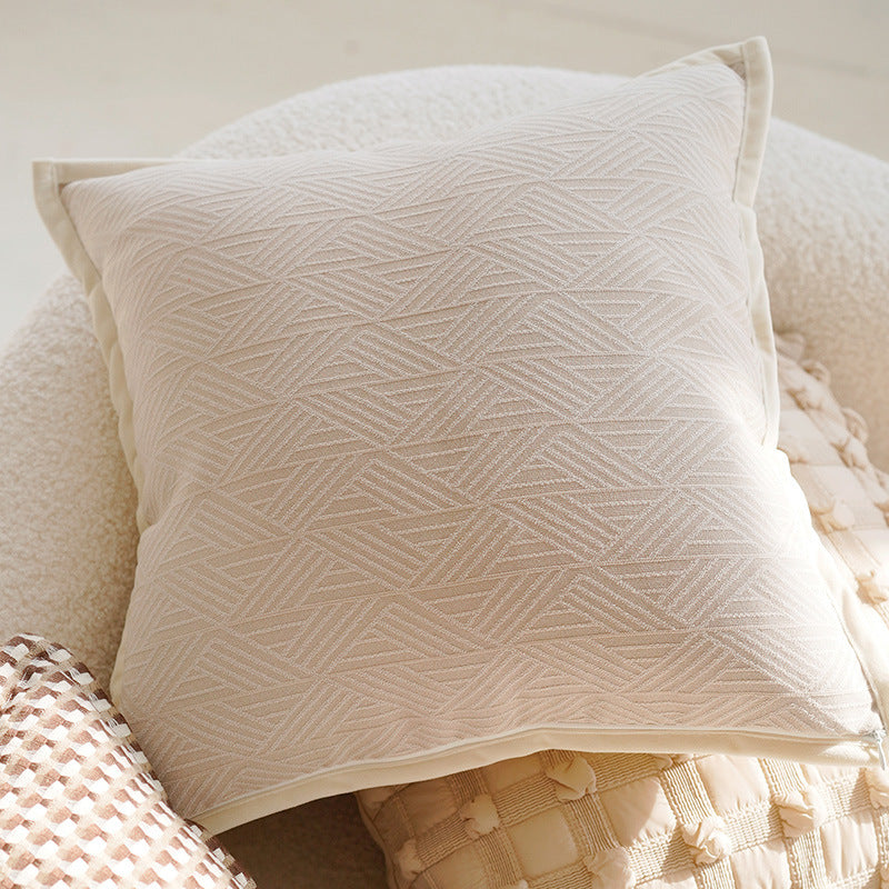 Textured beige pillow on a soft surface