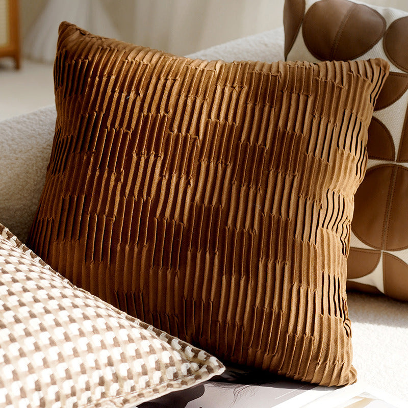 Brown textured pillow on a sofa with a blurred background
