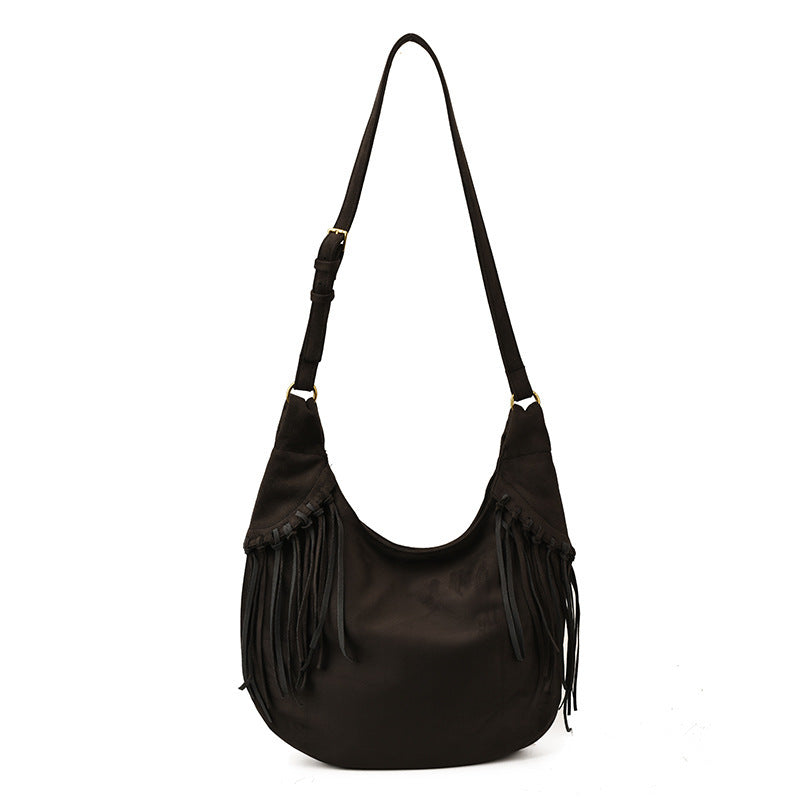 Black shoulder bag with fringes on a white background