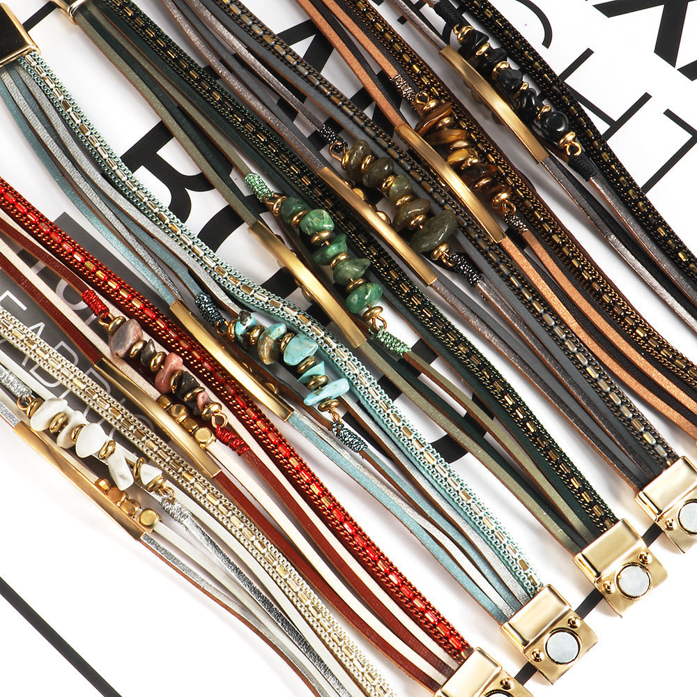 Collection of colorful leather bracelets with metal clasps on a white background