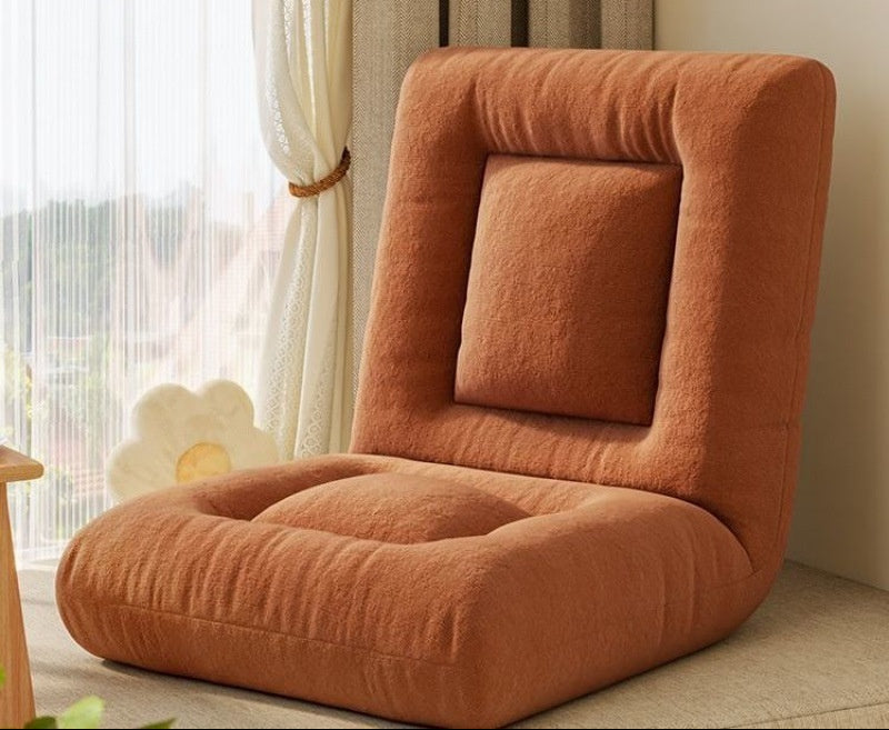 Orange floor pillow with adjustable positions in a room setting