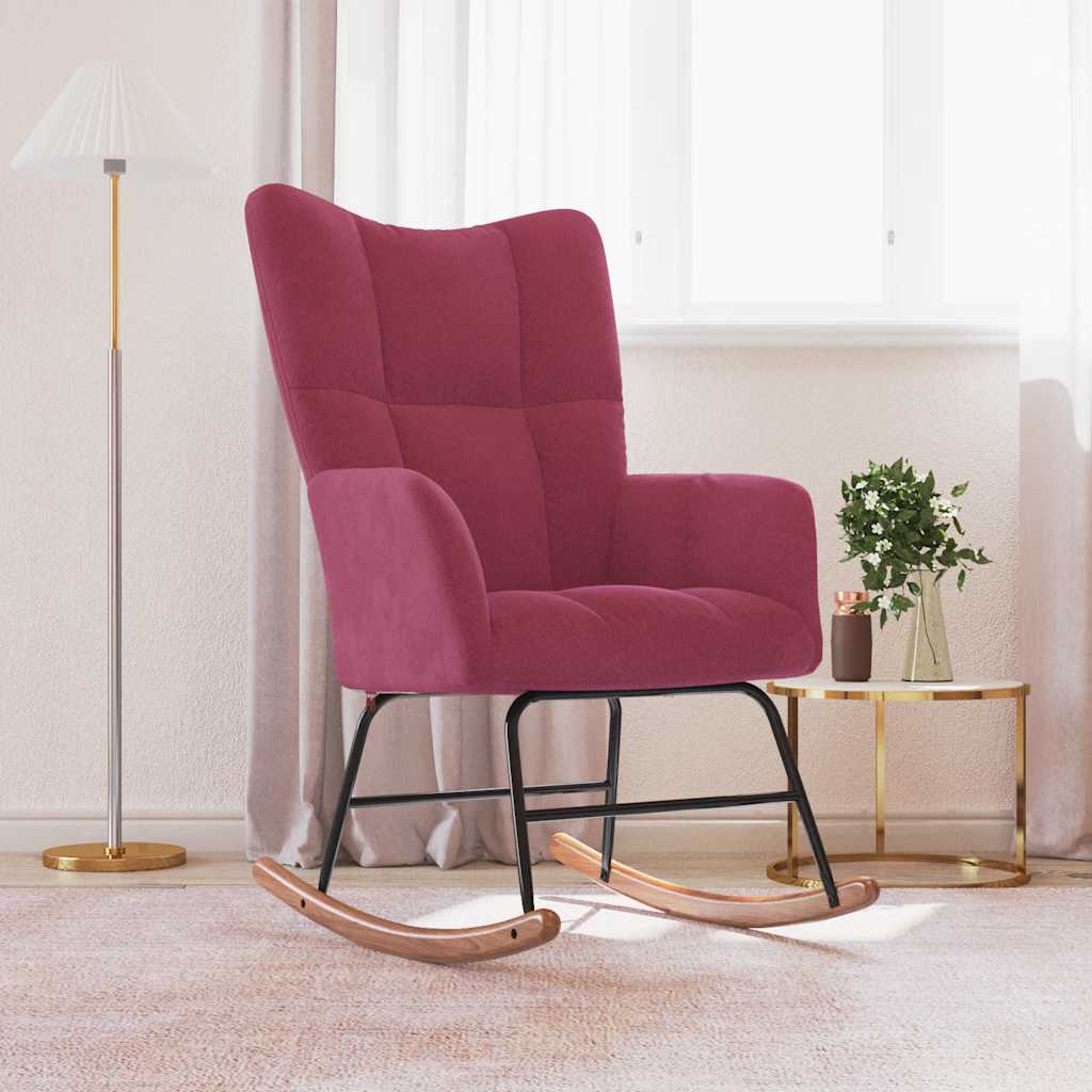 Pink rocking chair in a room with a lamp and small table