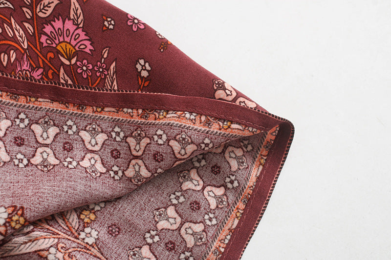 Close-up of a folded fabric with floral patterns on a white background
