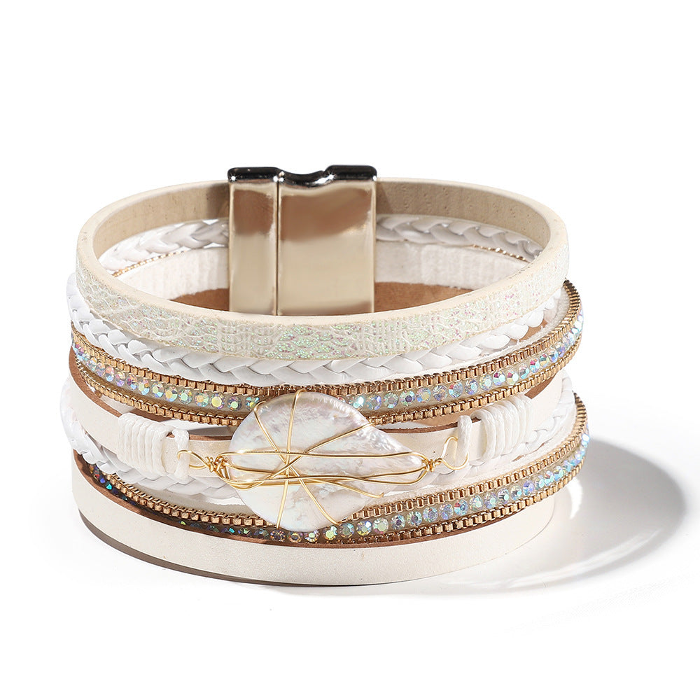 Multistrand bracelet with gold and silver accents on a white background