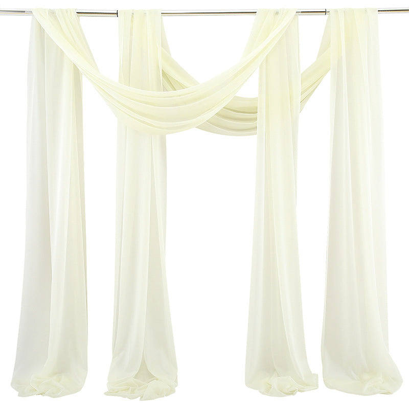 Sheer white curtains hanging from a rod on a white background