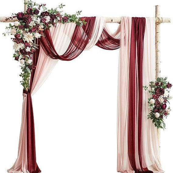 Decorative arch with burgundy and beige drapes and floral arrangements on a white background