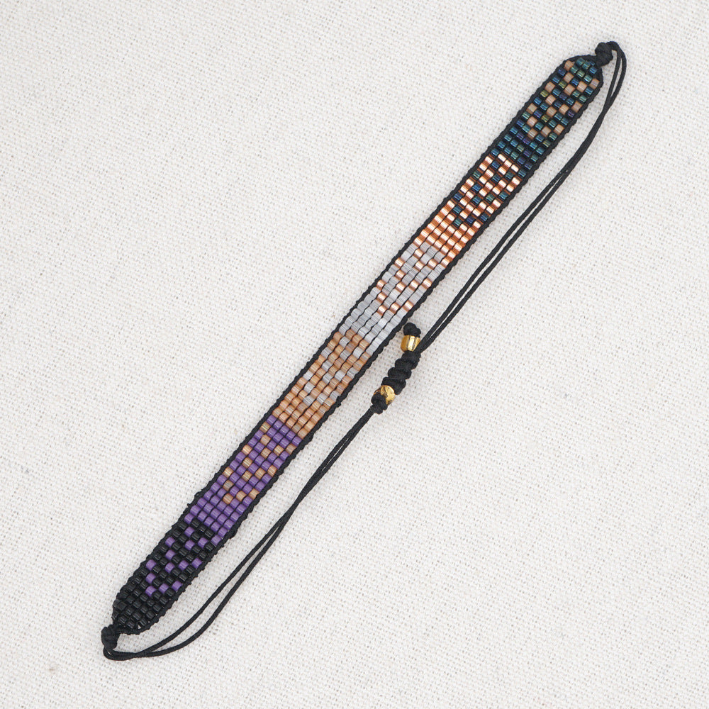 Beaded headband with black, purple, and orange pattern on a white background