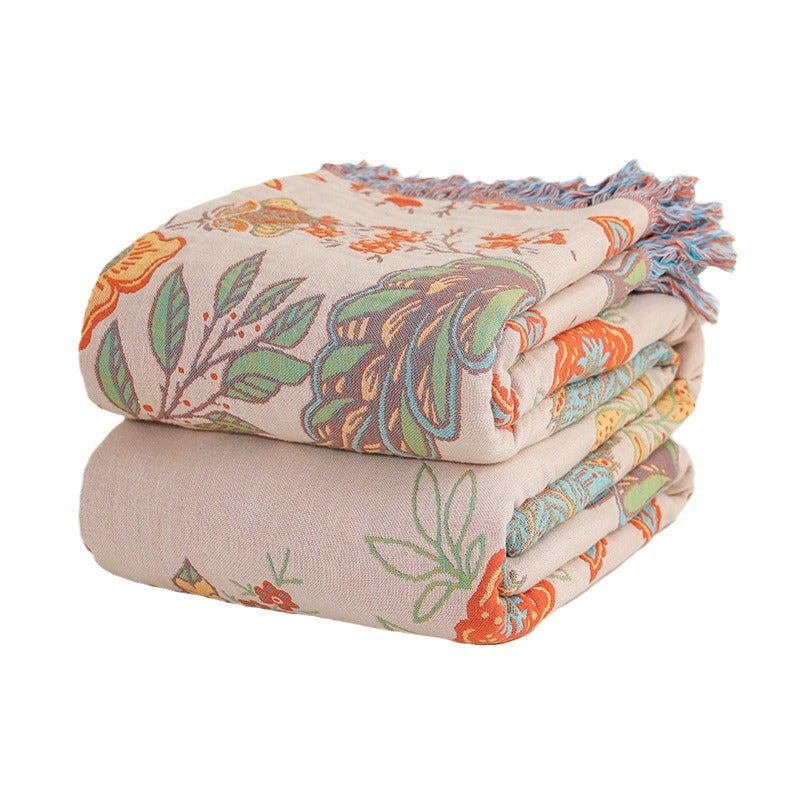 Folded floral-patterned blanket with colorful design on a white background