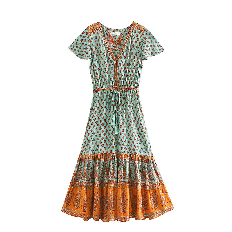 Green and orange patterned dress on a white background