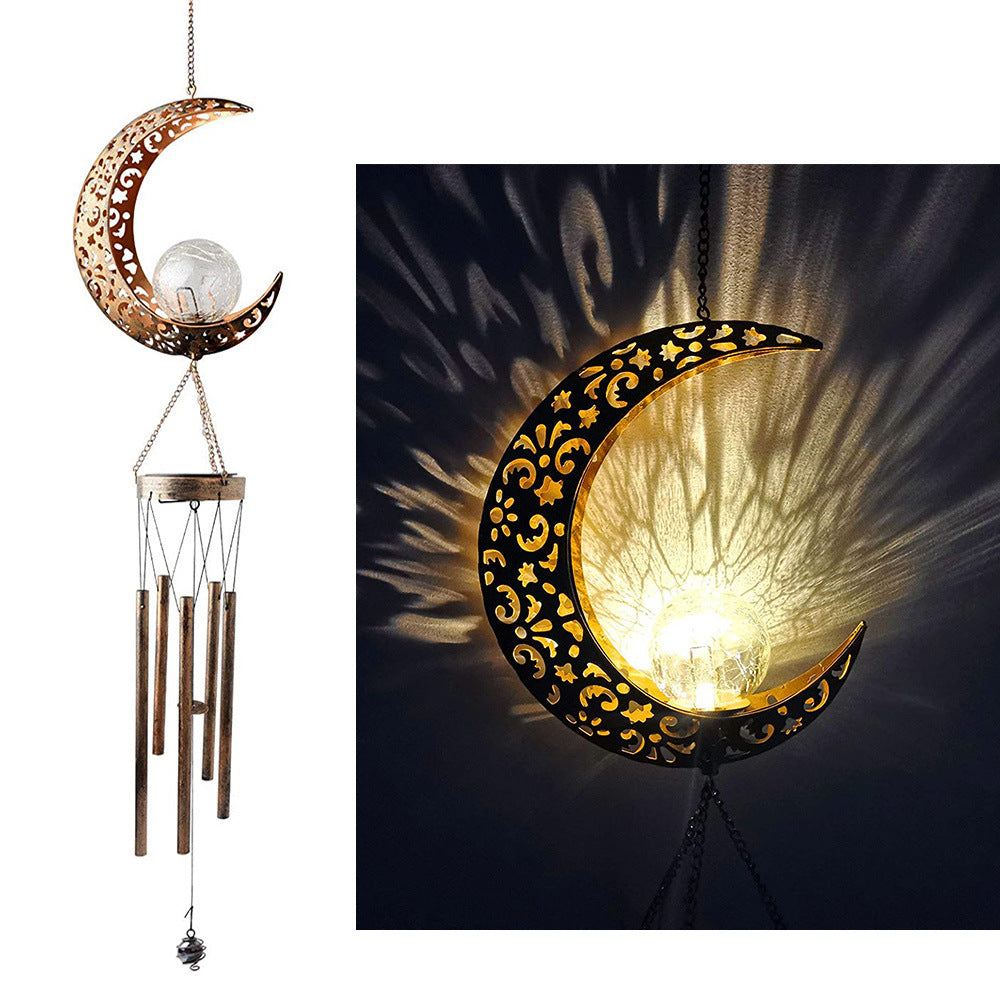 Decorative moon-shaped lamp with wind chimes on a white background