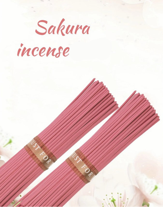 Pink incense sticks with 'Just For' labels on a white background with cherry blossom flowers.