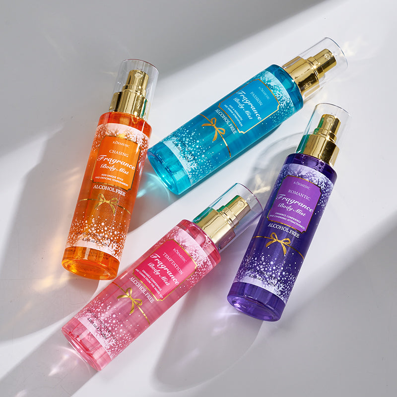 Four colorful spray bottles on a light background