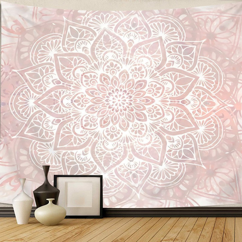 Decorative wall mural with a white floral mandala design on a light pink background, with vases and a picture frame in the foreground.