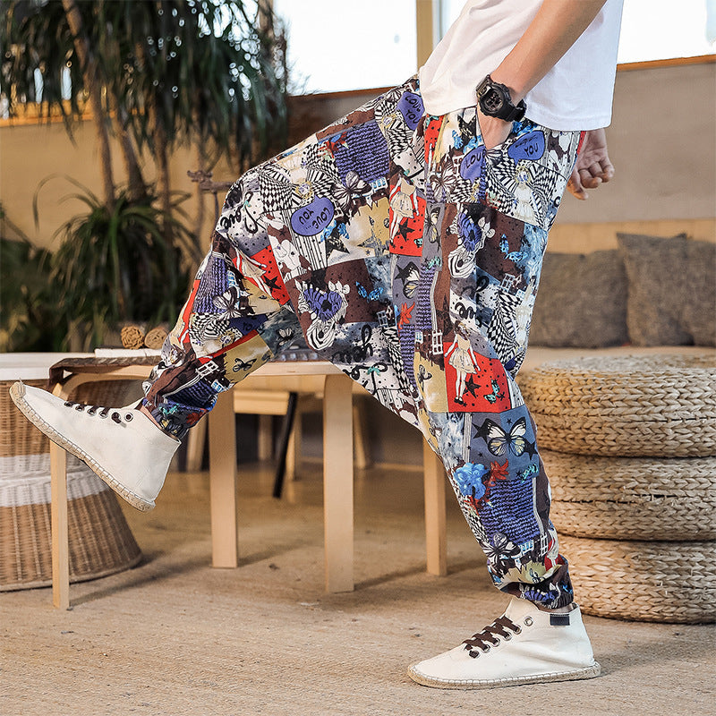 Person wearing colorful patterned pants with white sneakers in a casual setting.