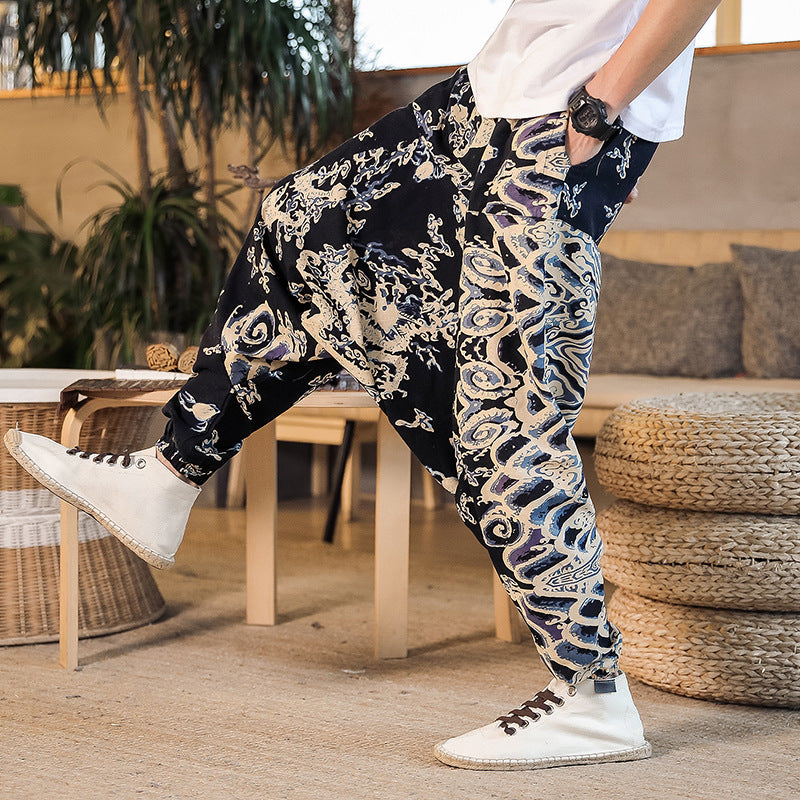 Person wearing patterned pants and white sneakers in a casual setting
