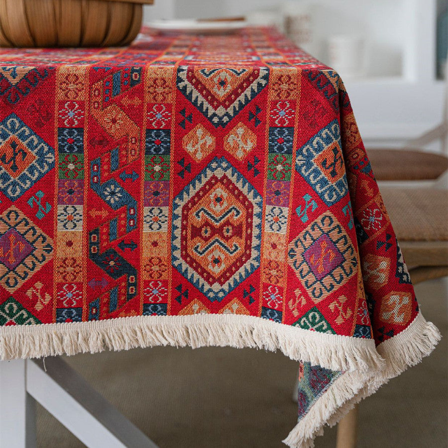 Colorful patterned tablecloth on a table with a blurred background