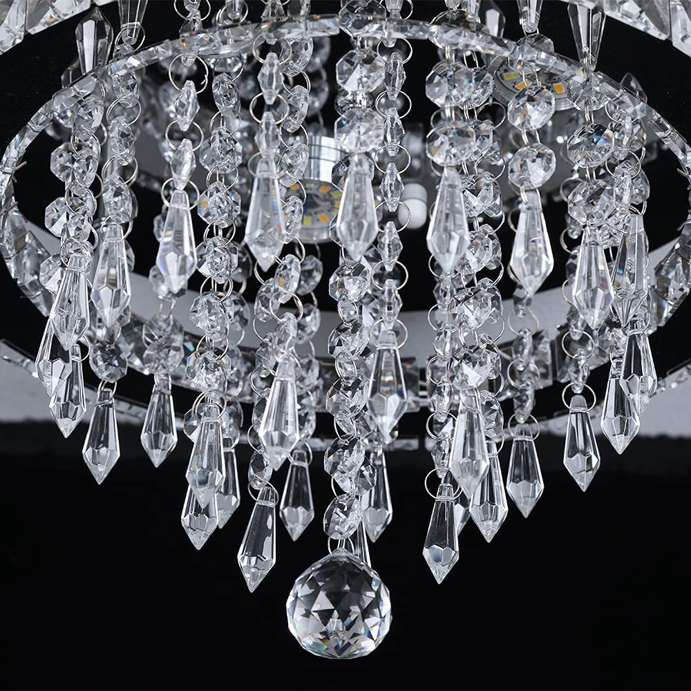 Close-up of a crystal chandelier with clear glass prisms against a black background