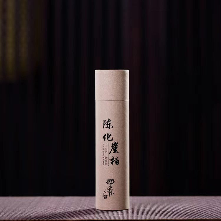 Cylindrical product packaging with text and a logo on a dark background