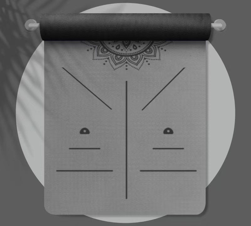 Dark gray and black yoga mat with mandala design on a white background
