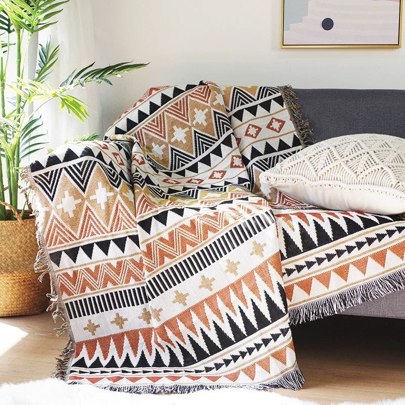 Decorative pillows with tribal patterns on a sofa in a living room setting.