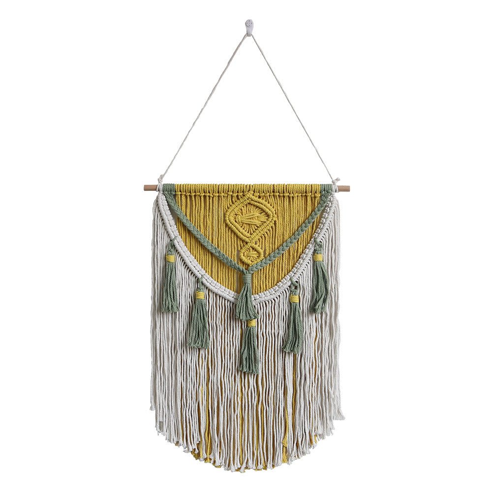 Macrame wall hanging with geometric pattern and tassels on a white background