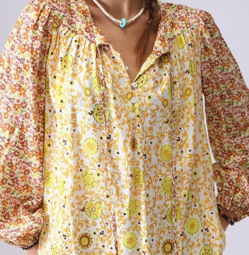Floral patterned shirt with long sleeves on a plain background