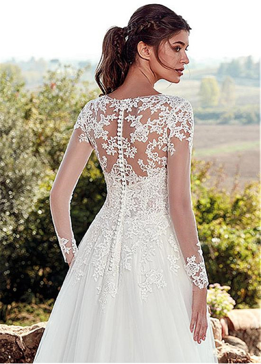 Woman wearing a white lace wedding dress with a scenic background