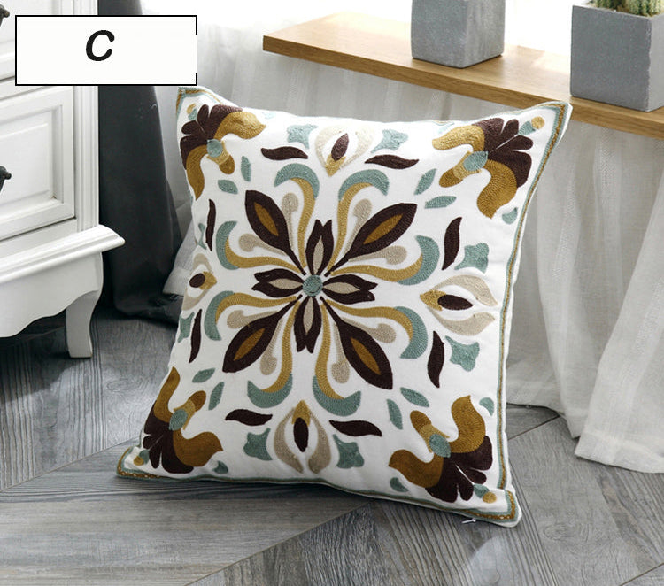 Decorative pillow with floral pattern on a wooden floor