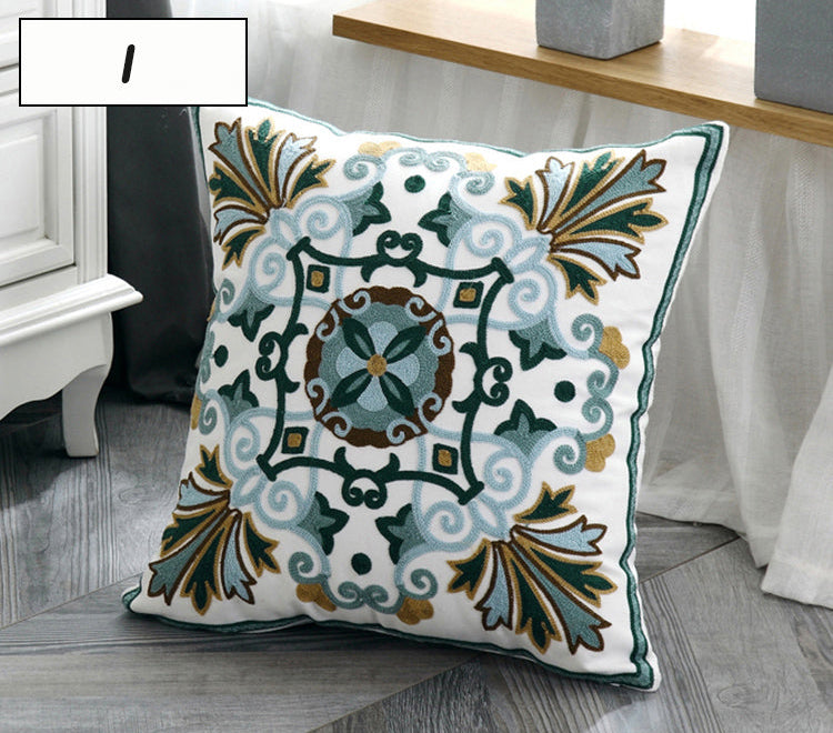 Decorative pillow with intricate patterns on a wooden surface