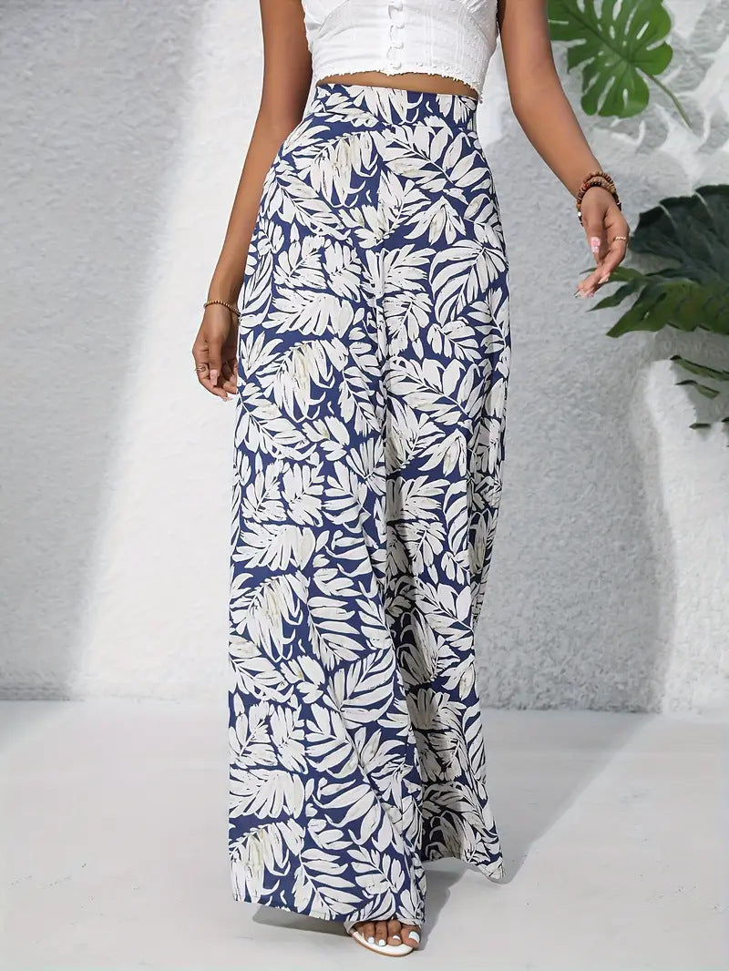 Person wearing blue and white leaf-patterned wide-leg pants against a gray background